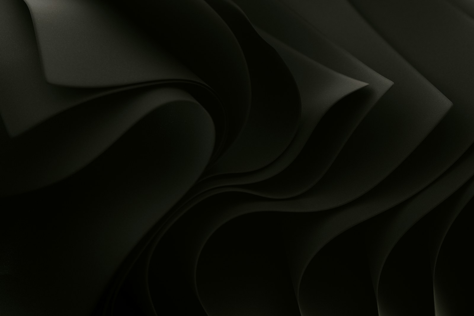 Dark sculptural folds layered in sequence